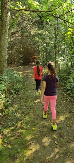 kids walking in the forest while geocaching