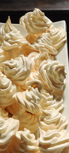 light and airy  meringue cookies on a platter