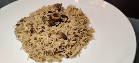 pilau rice with goat meat on a plate