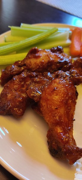 crispy air fryer chicken wings on a plate with vegetables