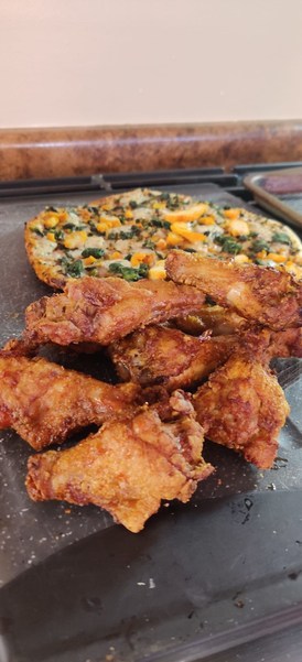 crispy air fryer chicken wings on a baking sheet before the sauce 