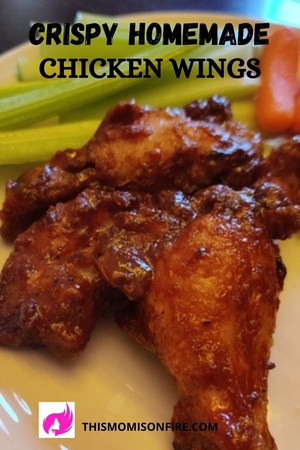 a close up shot of chicken wings with side celery and carrots. This is a pinterest pin.