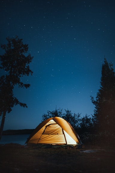 camping and sleeping in a tent at night