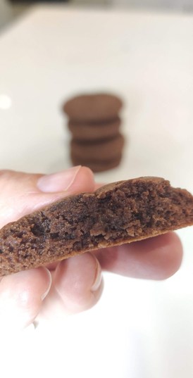 a person holding half a Nutella cookie