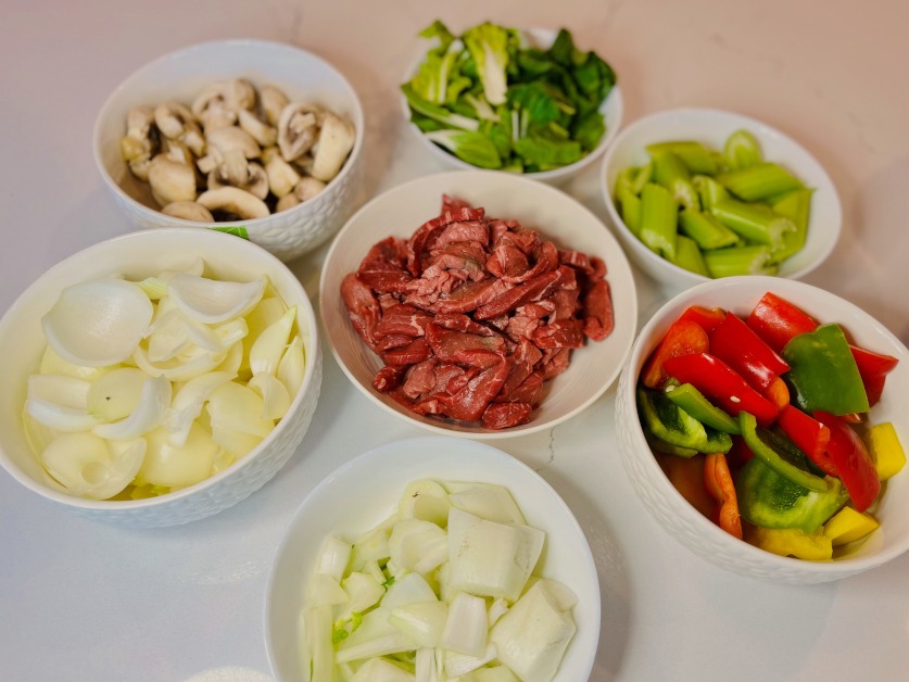 stir fry beef and vegetables cut up separately in bowls