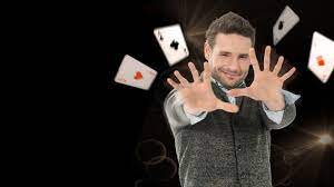 the main character from the show Tricked with playing cards coming from his hands
