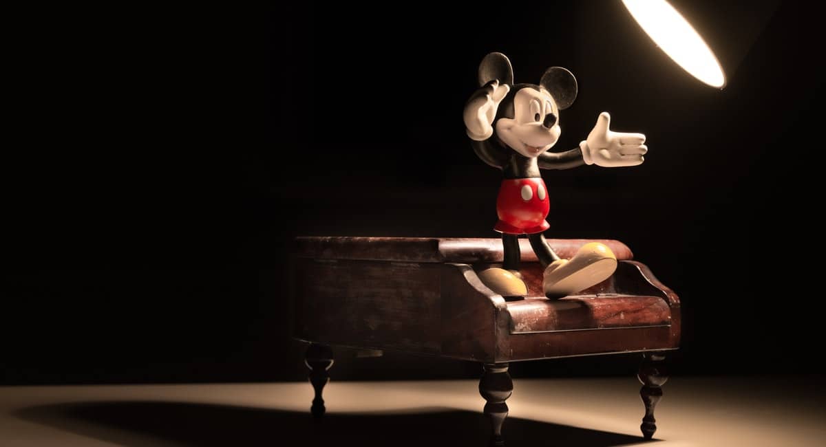 a small Mickey mouse figuring on a toy piano