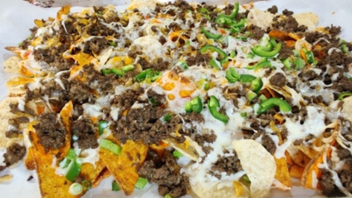 Ground beef nachos with doritos on a baking tray