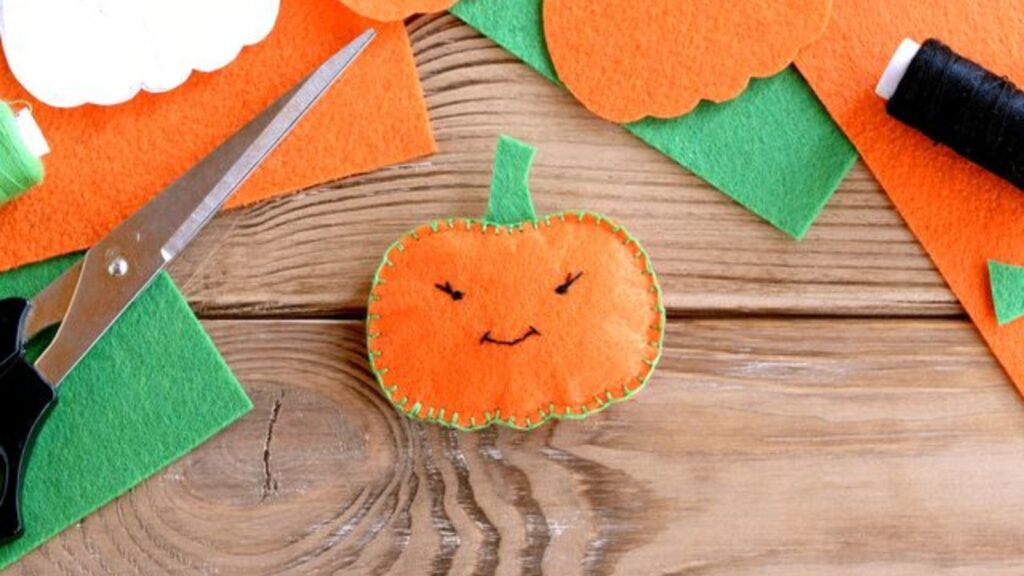 a pumpkin cut from felt for a Halloween decoration.