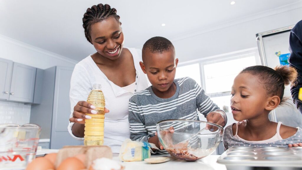 A mother baking with her son and daughter.