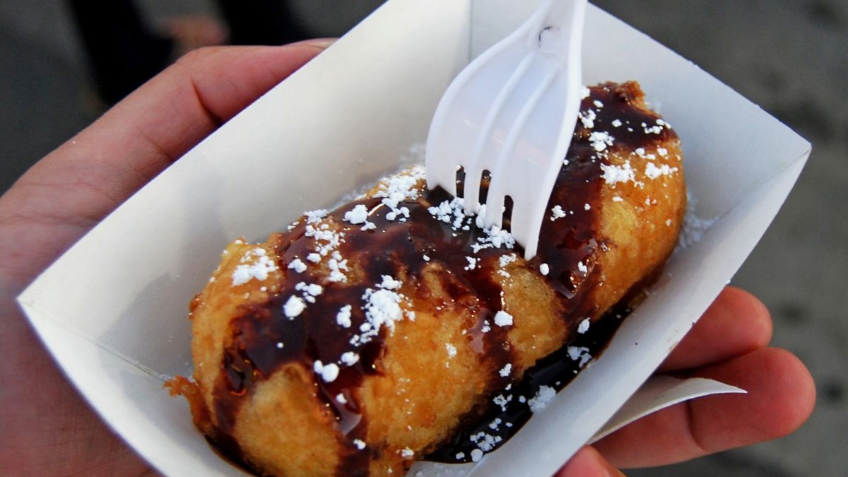 deep fried butter in a tray with a fork through it.