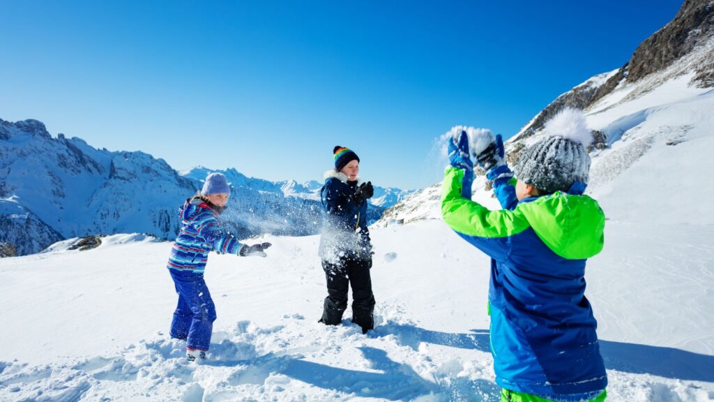 three kids having a snowball fight.