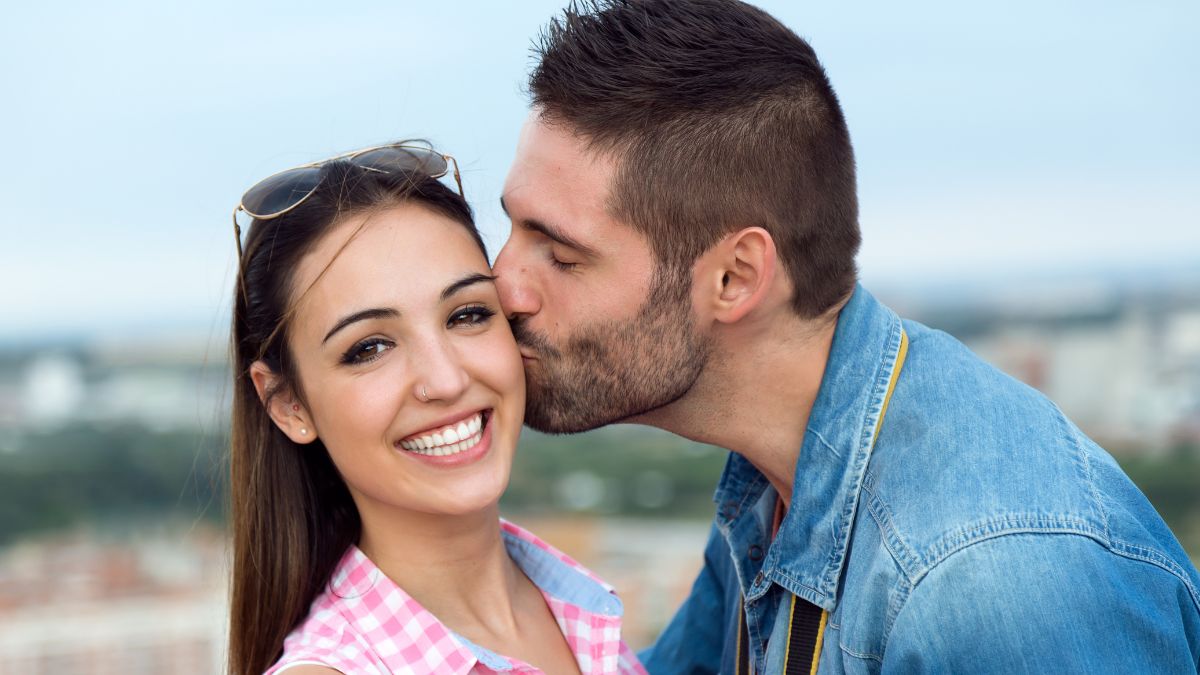 a man kissing a woman on the cheek