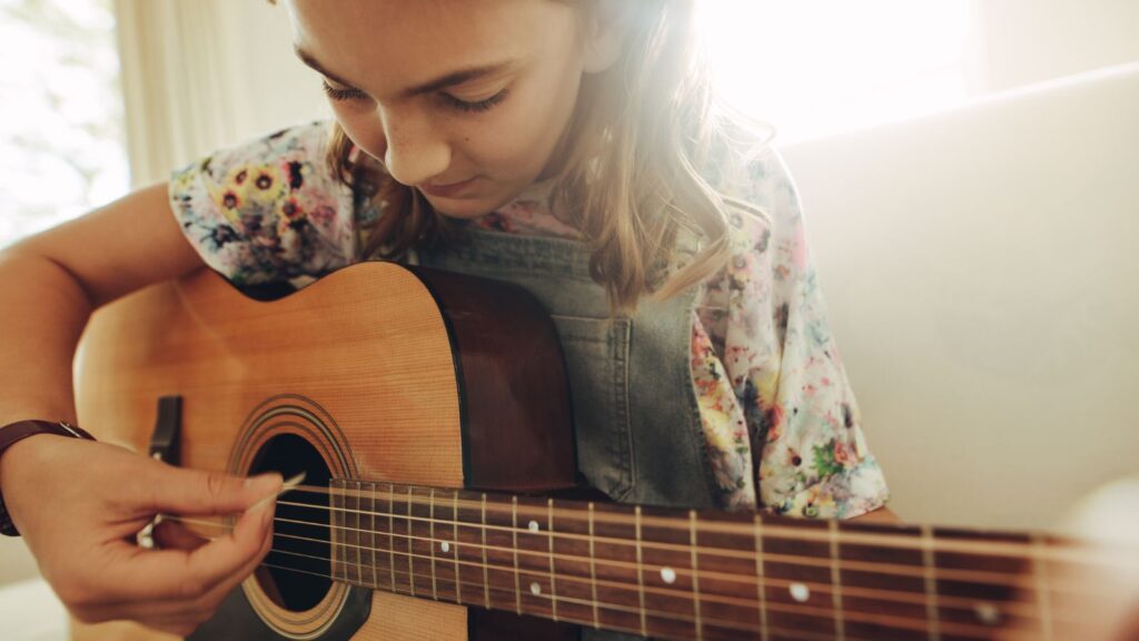 girl playing the guitar.