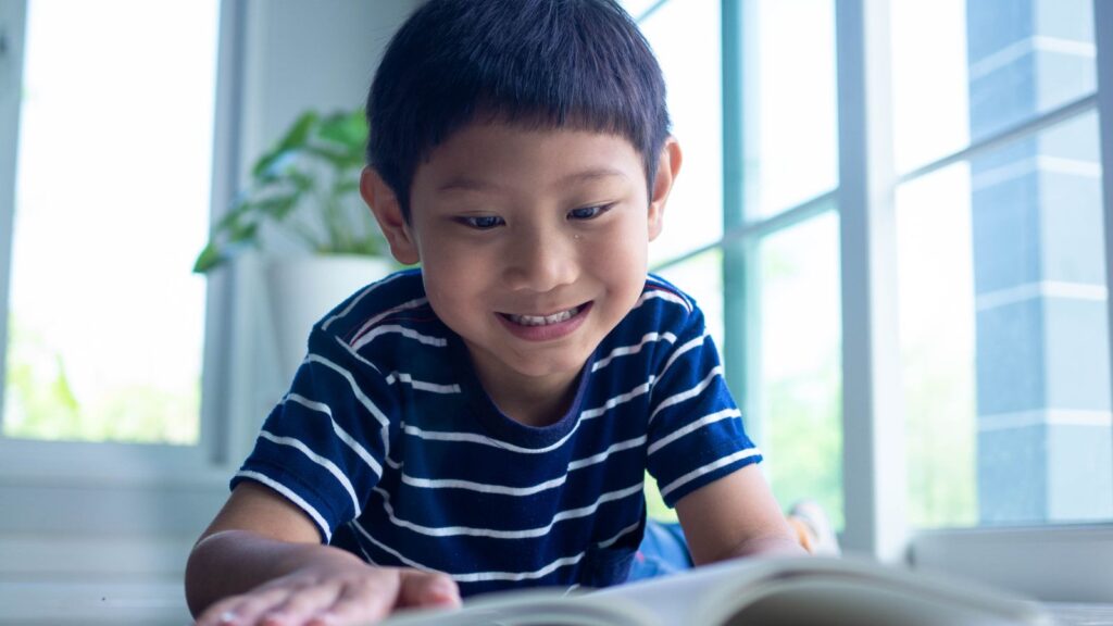 a boy reading a book.