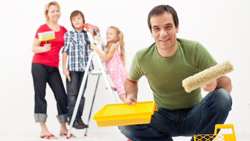 a family redecorating and holding painting supplies