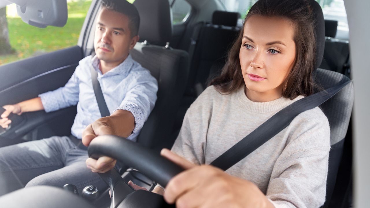 man teaching woman to drive