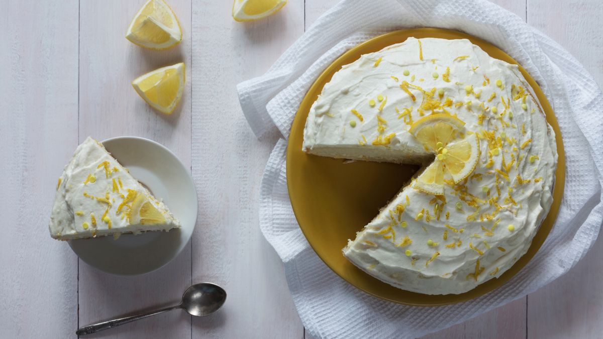lemon buttermilk cake with a slice on a plate beside it.