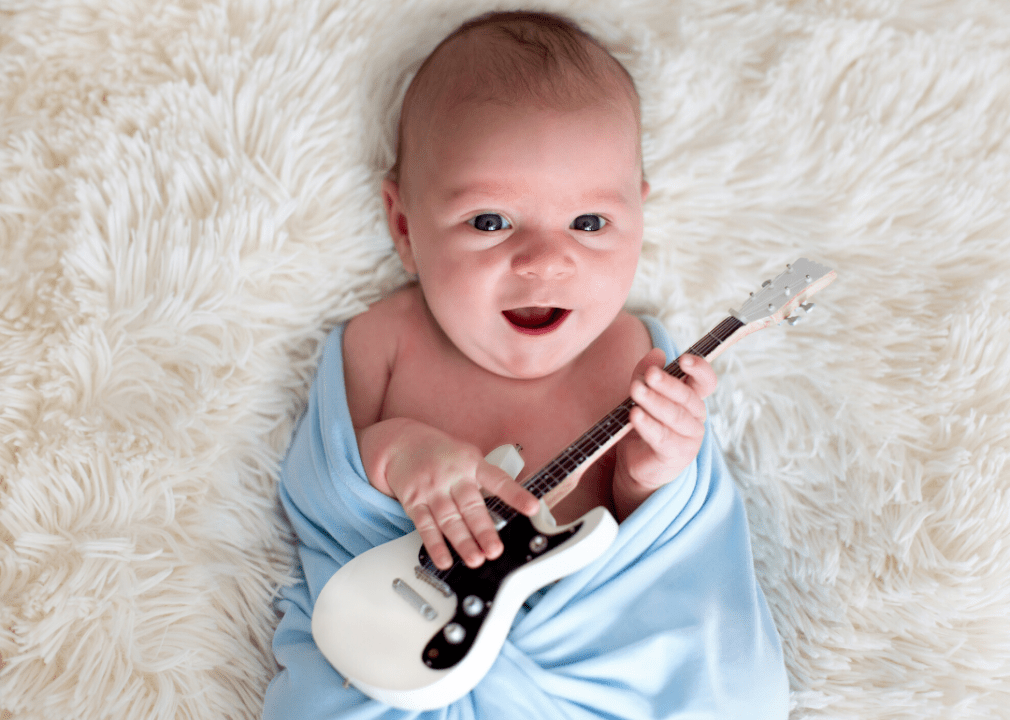 baby holding a guitar