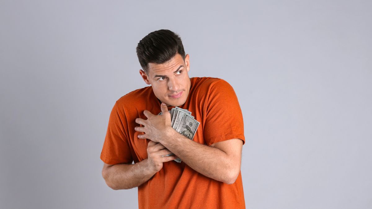 man holding on to money tightly