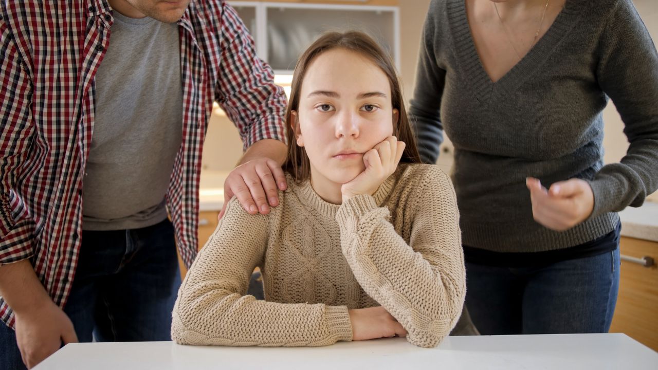 teenage daughter sitting between parents