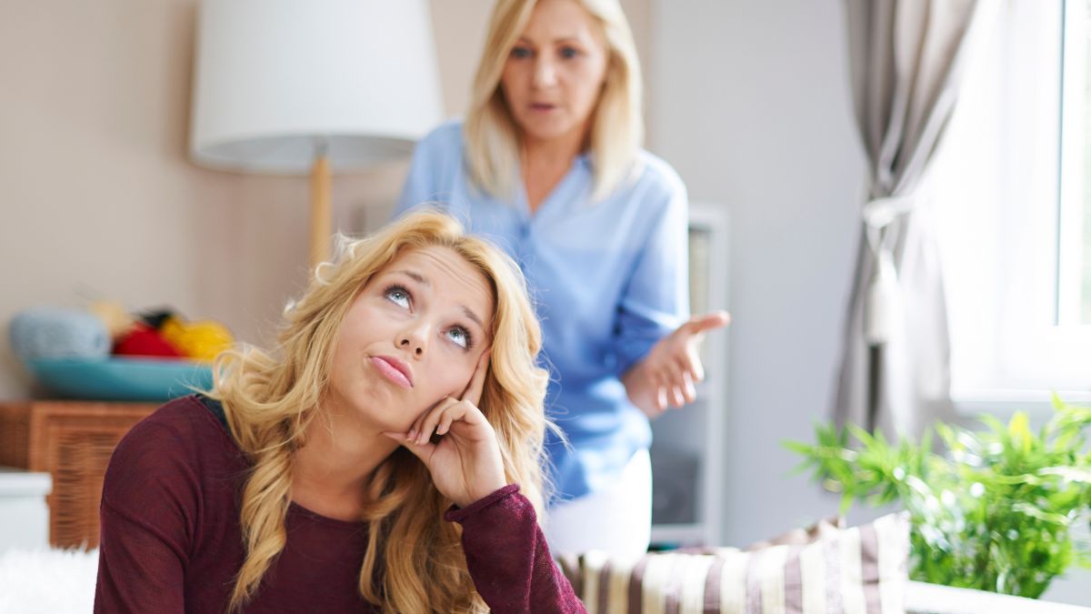 teenage daughter rolling her eyes while mother tried to talk to her