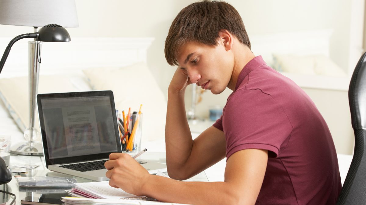 teenage boy trying to study