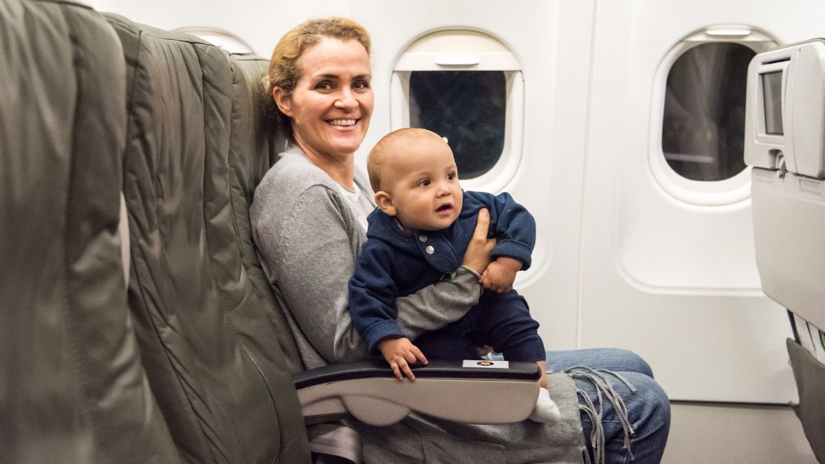 woman on airplane with baby