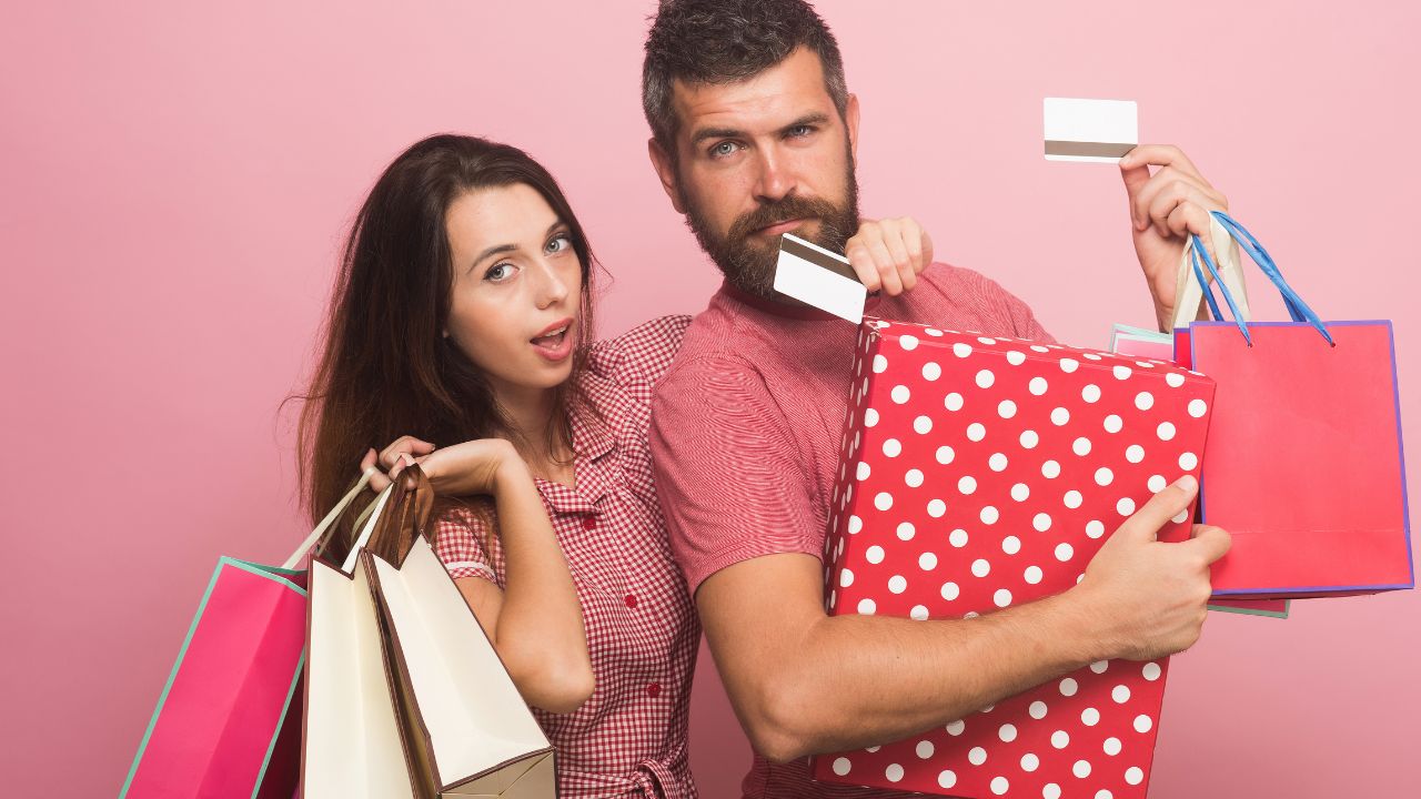 man and woman with shopping bags and credit cards