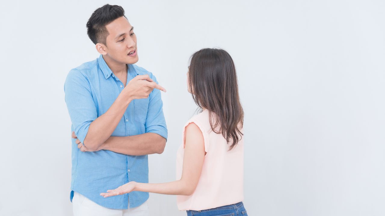 man pointing finger at woman