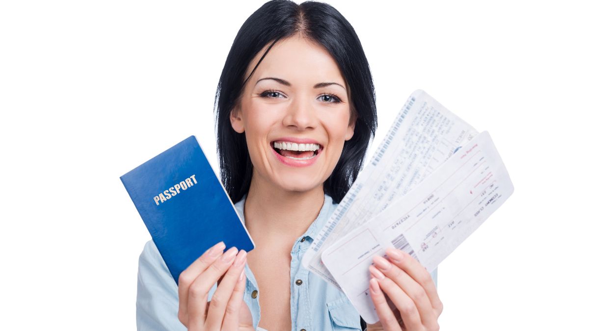 woman holding passport and flight tickets