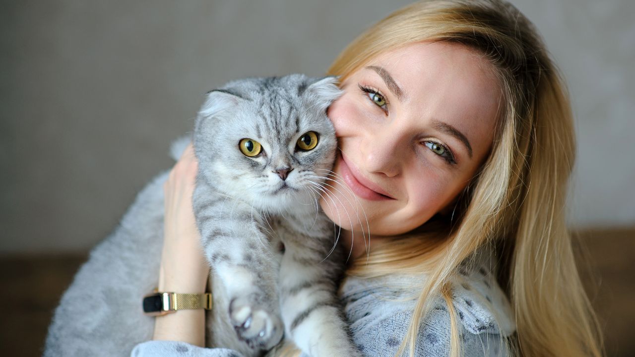 woman snuggling a cat
