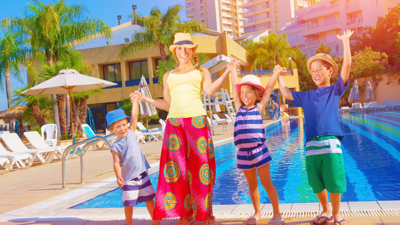 mother with kids at at hotel pool