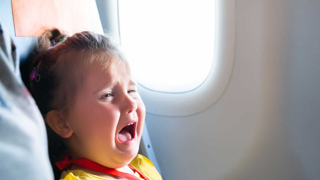 baby girl crying on airplane