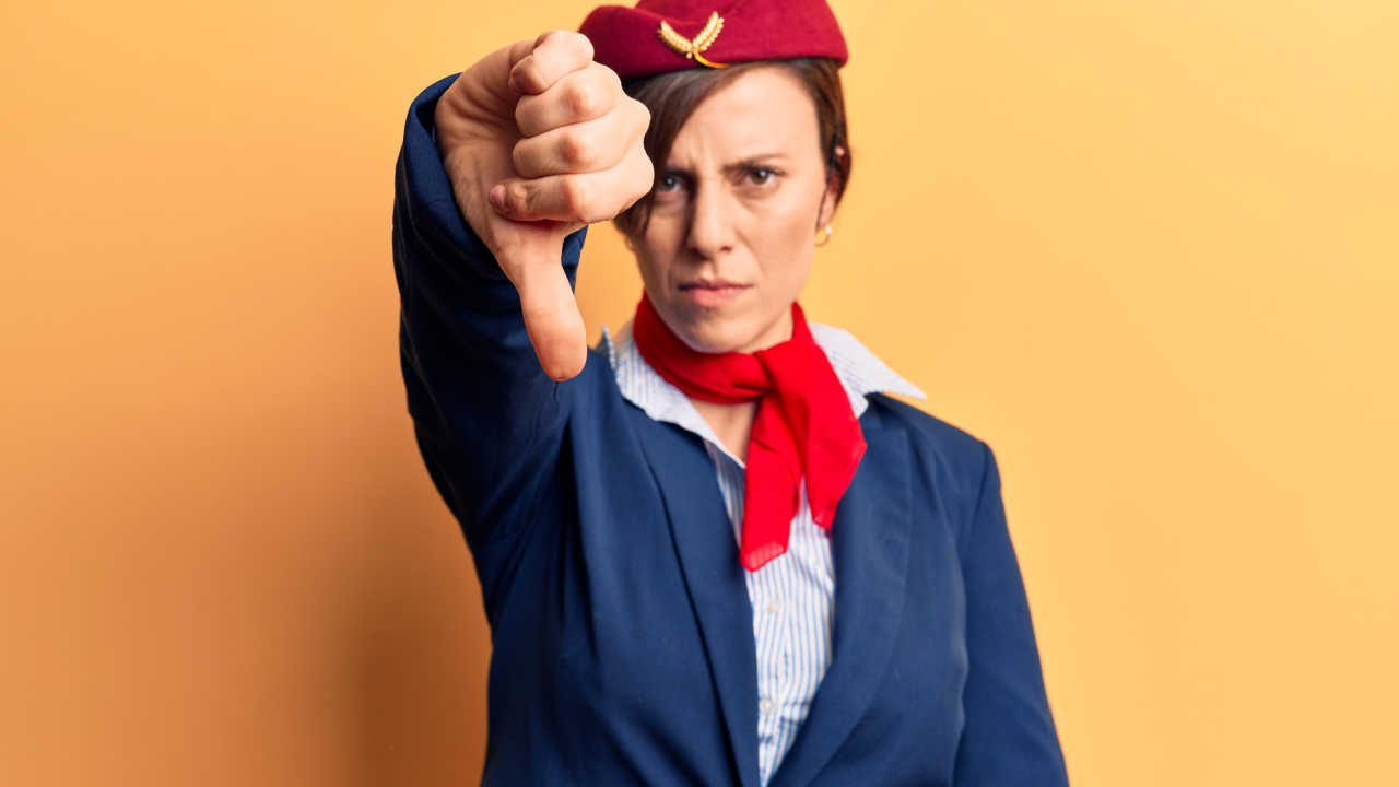 flight attendant giving thumbs down
