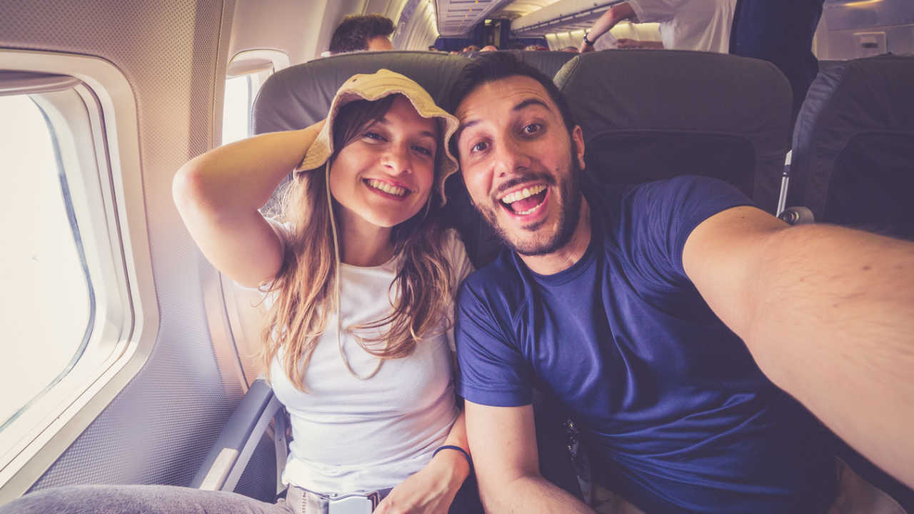 man and woman traveling in airplane