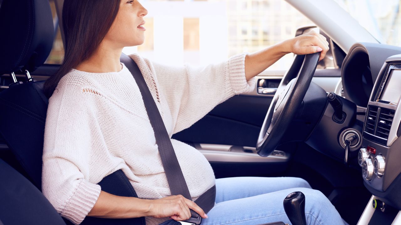 pregnant woman driving a car