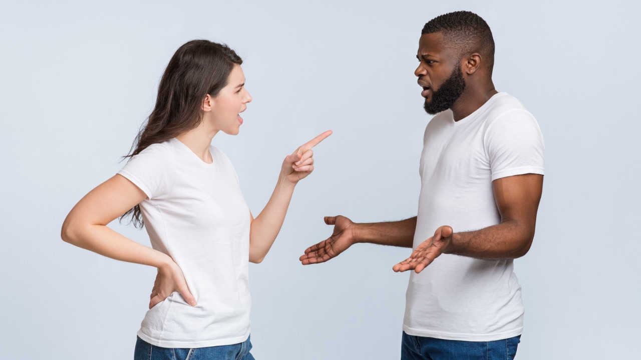woman arguing with man and pointing her finger at man