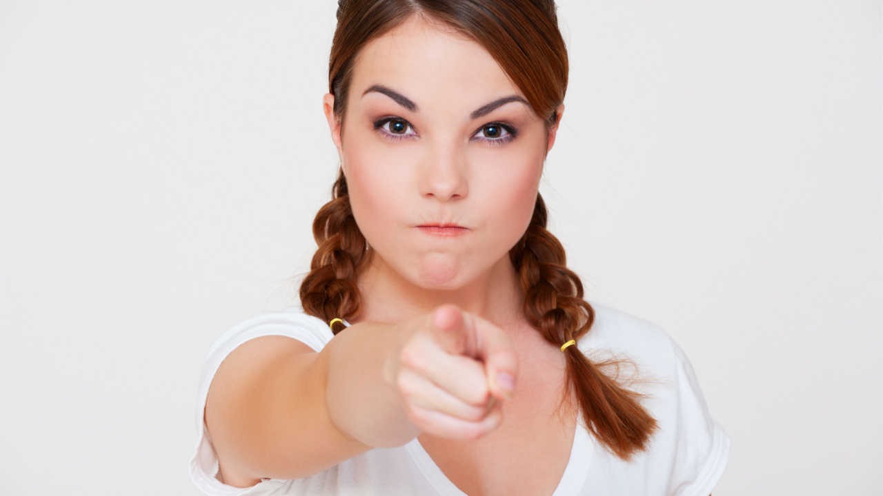 woman pointing her finger with angry face, lecturing or accusing someone.