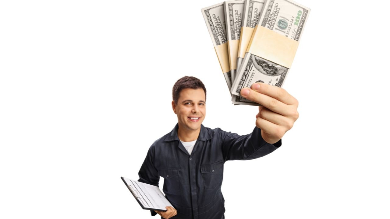 man holding a clipboard in one hand and money in the other hand