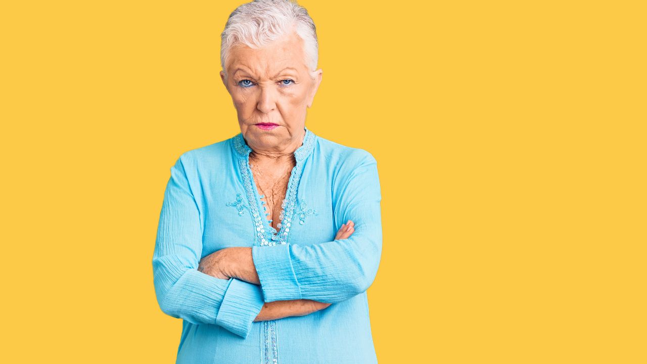 senior woman angry with arms crossed
