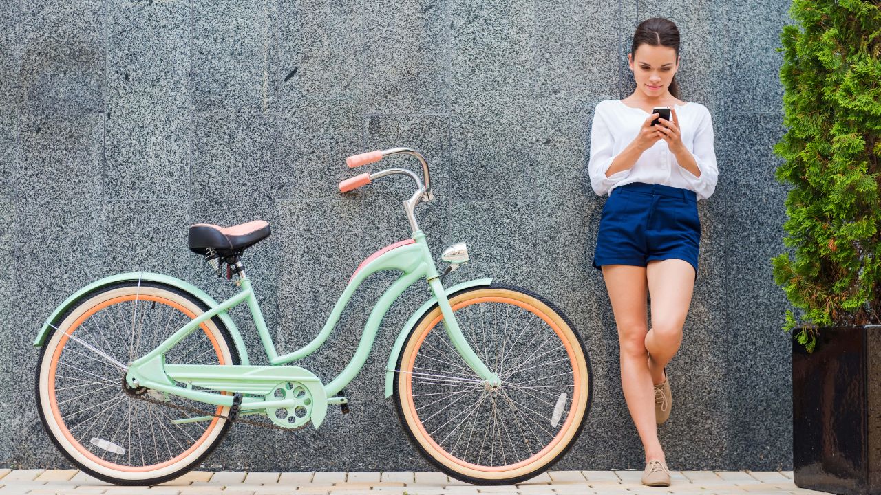 teenage girl beside a vintage bicycle
