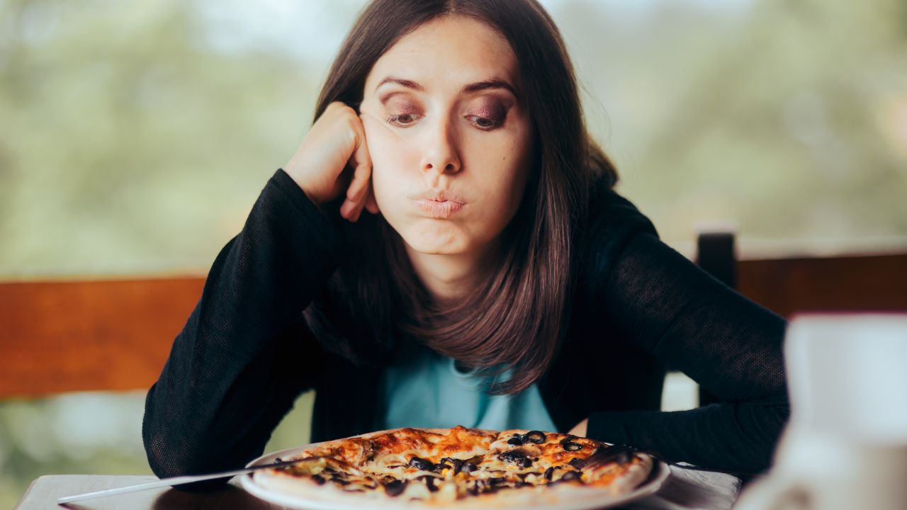 woman looking at her meal being a picky eater