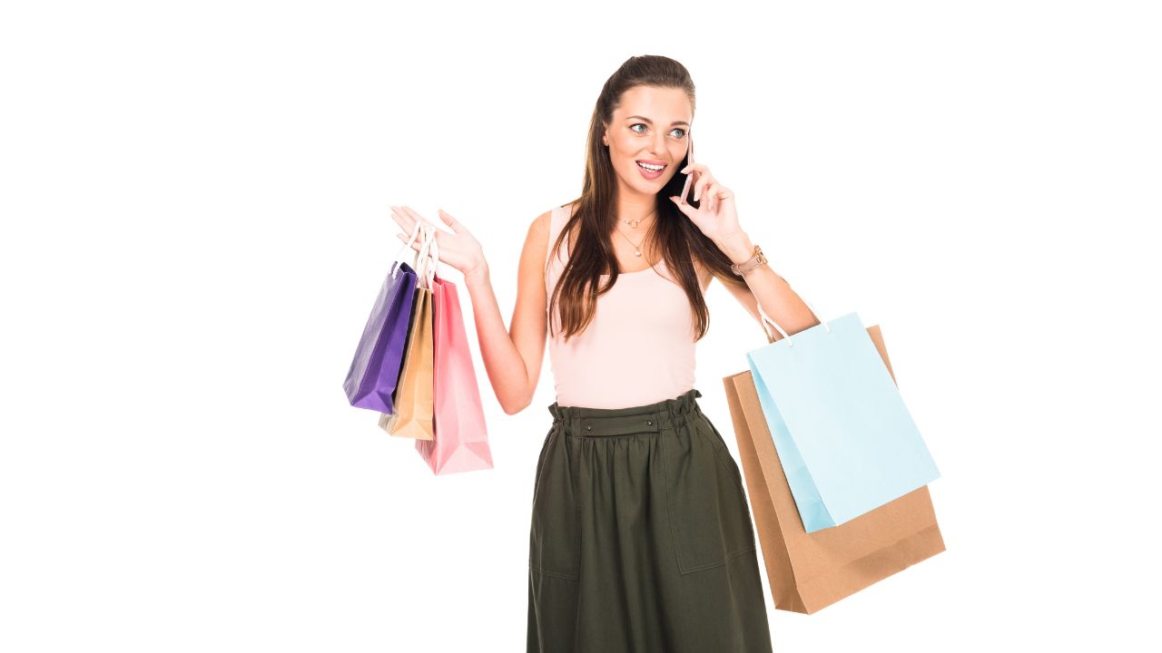 woman holding shopping bags and talking on the phone