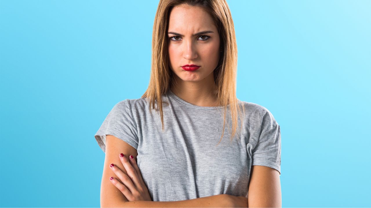 woman with arms crossed looking annoyed