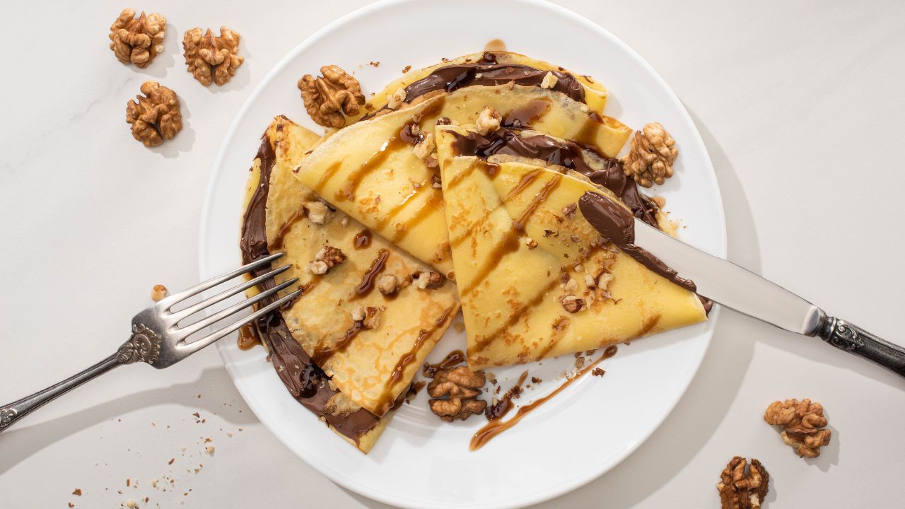 chocolate drizzled crepes on a plate