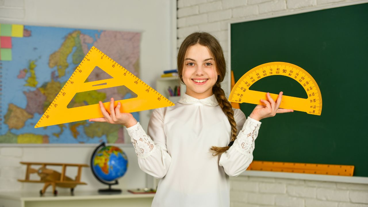 girl with measuring tools in a classroom