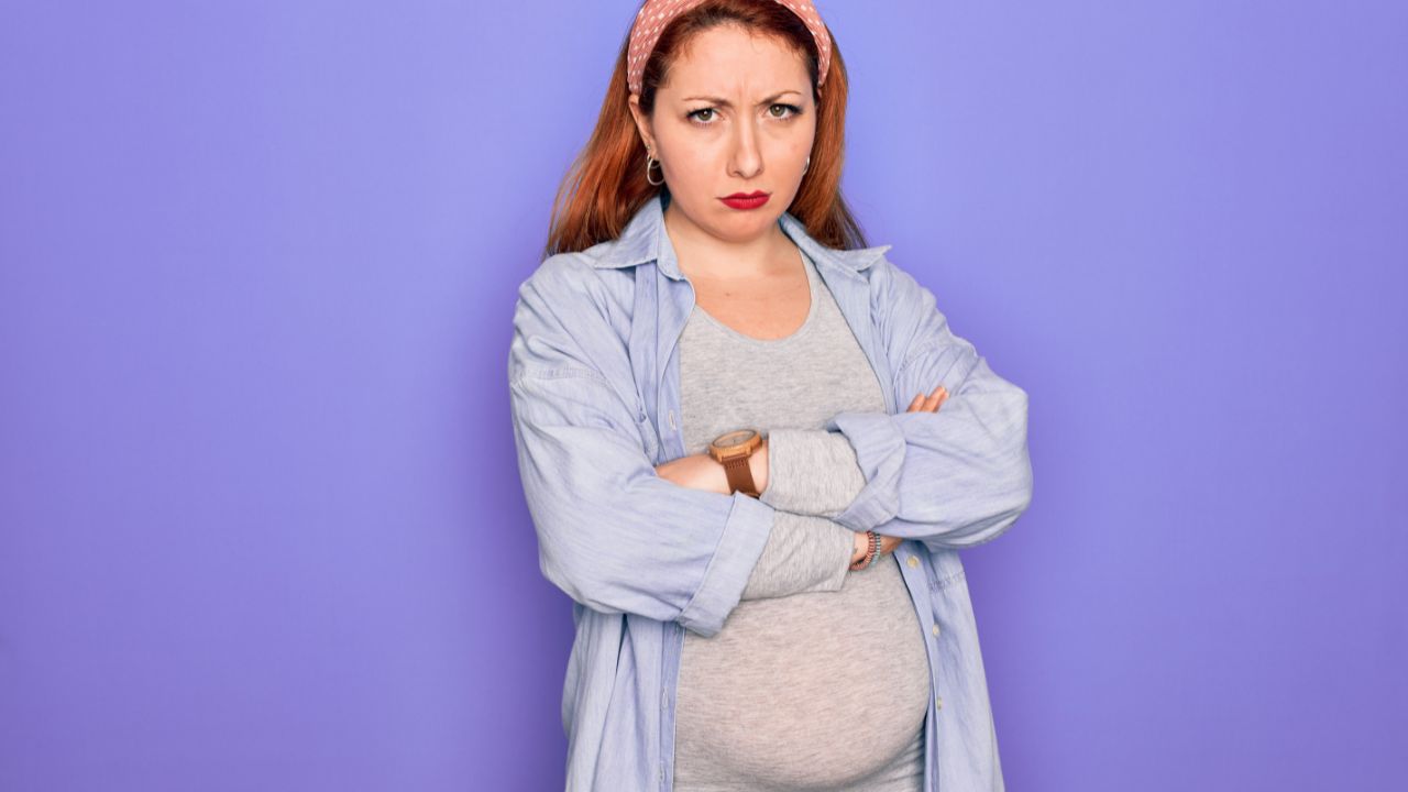 pregnant woman looking angry with arms crossed