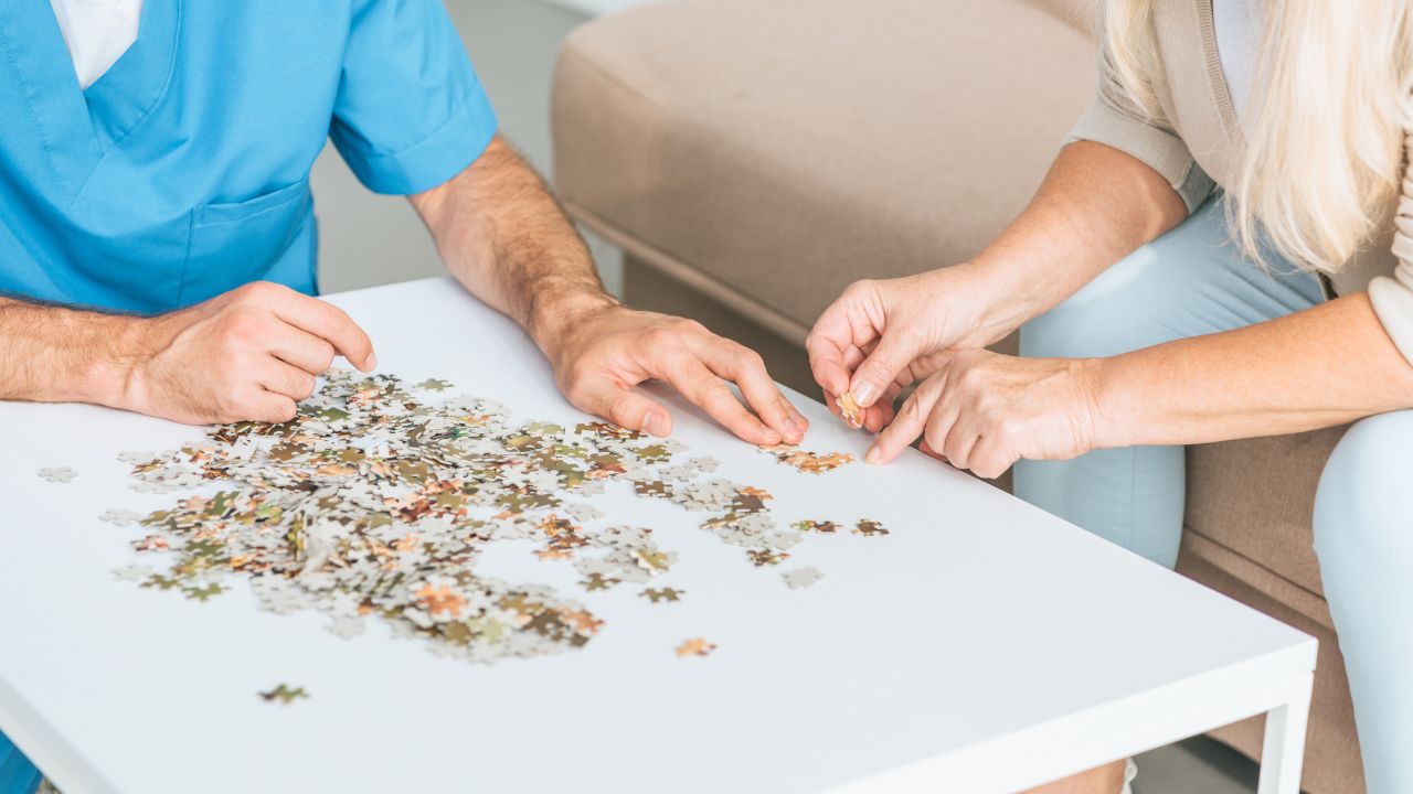 man and woman putting puzzle together