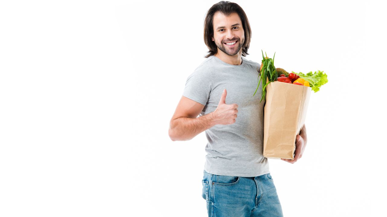 man holding bag full of groceries
